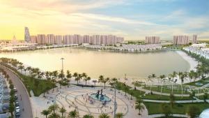 a large body of water with palm trees and buildings at Vinhomes Ocean Park Gia Lam by QMP in Hanoi +48 photos