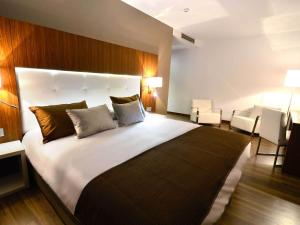 Postel nebo postele na pokoji v ubytování Gran Hotel Botánicos