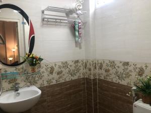 ein Bad mit einem Waschbecken und einem Spiegel in der Unterkunft Bac Huong House in Tuy Hoa