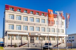 a building with a car parked in front of it at Comfort Hotel in Novosibirsk