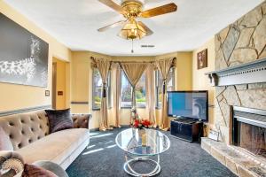 a living room with a couch and a tv and a fireplace at Sweet Home Georgia - Entire 3 bedroom Luxury in Duluth