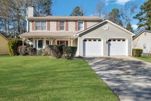 a large house with two white garage doors at Sweet Home Georgia - Entire 3 bedroom Luxury in Duluth