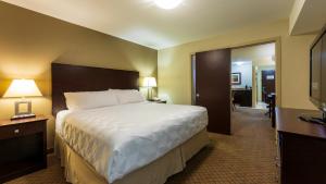 a hotel room with a large bed and a hallway at Holiday Inn Hotel and Suites-Kamloops, an IHG Hotel in Kamloops