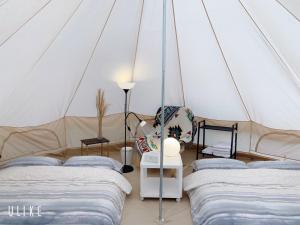 a room with three beds in a tent at Star Valley in Nanzhuang