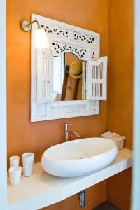 a bathroom with a white sink and a mirror at 2 bedrooms house with private pool and furnished garden at Ceglie Messapica in Ceglie Messapica