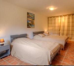 Postel nebo postele na pokoji v ubytování Appartement confortable à Moltifao, vue sur montagne, 50 m²