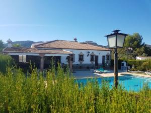 a villa with a swimming pool and a house at 3 bedrooms house with private pool enclosed garden and wifi at Arriate in Arriate