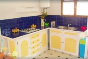 a kitchen with a sink and a stove in it at Maison accueillante avec jardin à Fort-de-France in Fontaine de Moutte