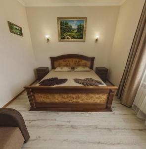 A bed or beds in a room at Polyana Apart