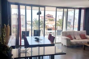 a living room with a couch and a coffee table at Spacious apartment with sea view in El Grau de Moncofa, 108m² in Moncófar
