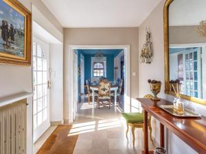 a dining room with a table and a mirror at Villa charmante à Roscoff avec vue sur la mer in Roscoff