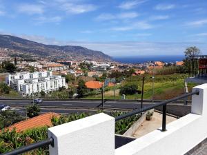 a view of a city from a balcony of a building at Charming House in Funchal with Sea View in Funchal