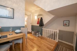 a dining room with a wooden table and a ceiling at 25 Church Street in Keswick