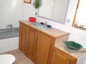 a bathroom with a sink and a mirror at Villa Luxueuse Grillon - Piscine in Grillon +16 photos