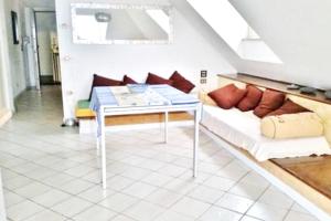 a living room with a couch and a table at One bedroom appartement at Mascali 10 m away from the beach with sea view furnished terrace and wifi in Mascali