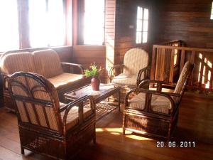 a group of chairs and a table in a room at 4 bedrooms house at Toamasina 50 m away from the beach with sea view and enclosed garden in Toamasina