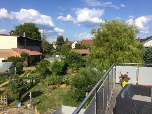 a view of a garden from a balcony at Appartement spacieux avec terrasse et jardin à Lohr, 120 m². in Lohr