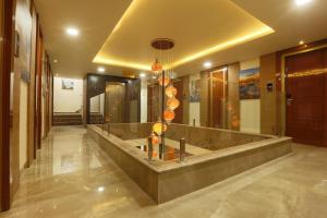a lobby with a long counter in a building at Hotel Omega - Gurgaon Central, Sec 45 in Gurgaon +49 photos