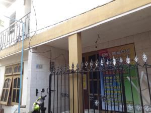 a scooter parked in front of a building with a gate at Homestay Mas Arjuna - Female Only in Bagongsabrangan