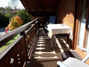 a table on the side of a porch at Apartment Utschneider-Holzer in Bad Bayersoien