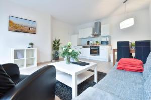 a living room with a couch and a table at Villa Kaja Wohnung Seebrücke in Korswandt