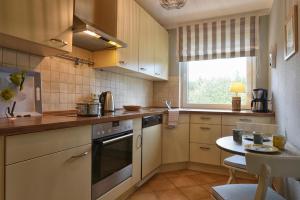 a small kitchen with a table and a window at Haus Halligblick Wohnung 18 in Wyk auf Föhr