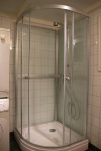 een badkamer met een glazen douchecabine bij Skomakergarden in Ulsteinvik