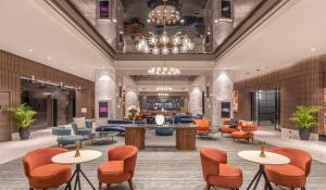 a lobby of a hotel with tables and chairs at President - IHCL SeleQtions in Mumbai