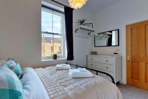 a bedroom with a bed and a dresser and a window at Finest Retreats - Peak Dale Apartment in Matlock