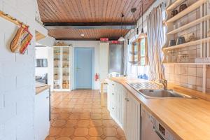 a kitchen with a sink and a counter top at Ferienhaus Broderswarft in Dagebüll