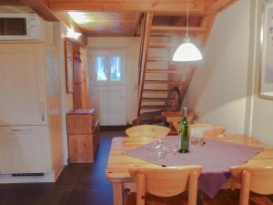 a dining room with a table with a bottle of wine at Koog in Humptrup