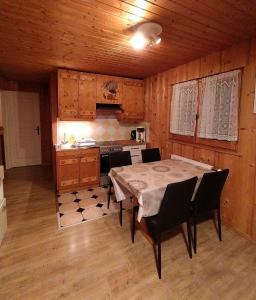 a kitchen with a table and chairs in a room at Appartement Daria in Prémanon