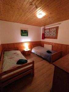 a bedroom with two beds and a wooden ceiling at Appartement Daria in Prémanon