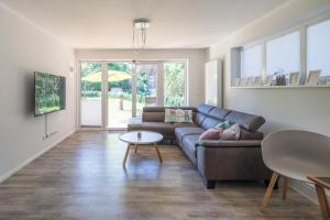 a living room with a couch and a table at Villa Lütt-KEINE MONTEURE- in Husum