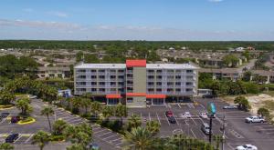 an aerial view of a hotel with a parking lot at Baymont by Wyndham Panama City Beach in Panama City Beach