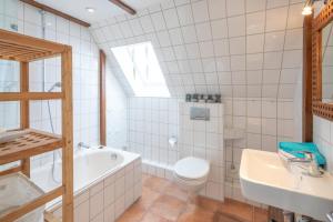 een badkamer met een toilet, een bad en een wastafel bij Seaside in Westerland