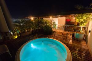a hot tub on a deck at night at Luxor Paulo Miranda Home Service in João Pessoa