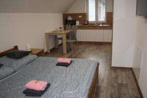 a bedroom with two beds with pink towels on them at Andriš Apartmány in Spišské Bystré