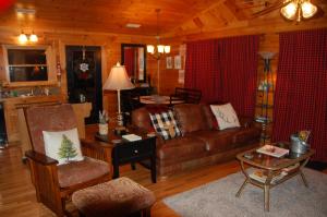 a living room with a couch and a table at His Promises Cabin in Pigeon Forge