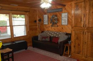 a living room with a leather couch in a cabin at His Promises Cabin in Pigeon Forge