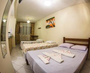 Ein Bett oder Betten in einem Zimmer der Unterkunft Chalés Pipa
