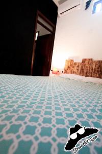 a carpeted floor with a pair of shoes on it at Straw Hat Hostel & Rooftop Bar in Tulum