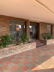 a building with a m sign in the window at Hotel Half Moon Chennai in Chennai