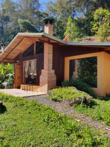 a small brick house with a chimney on top at El Toucanet Lodge in El Copey