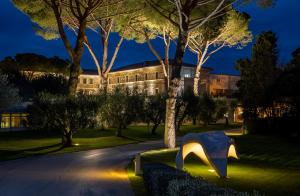 a sculpture in front of a building at night at Terme di Saturnia Natural Spa & Golf Resort - The Leading Hotels of the World in Saturnia