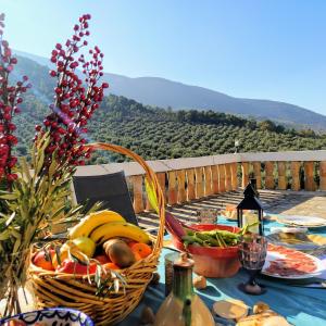 a table with a basket of fruit and vegetables on it at Alojamiento Rural Medios Panes in Puerto Alto