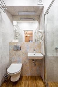 a bathroom with a toilet and a sink at Romari ВІП Апартаменти на площі Ринок in Lviv