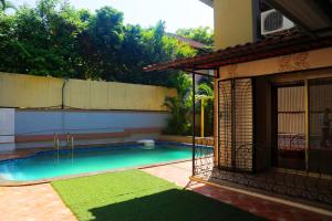 a swimming pool in the backyard of a house at Aroma Villas in Lonavala +45 photos