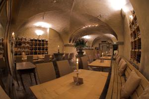 a restaurant with tables and chairs and a wine cellar at Hotel Hirschen in Zürich