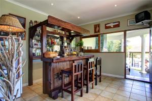 
a dining room with a wooden table and chairs at Waterfront Lodge in Knysna
